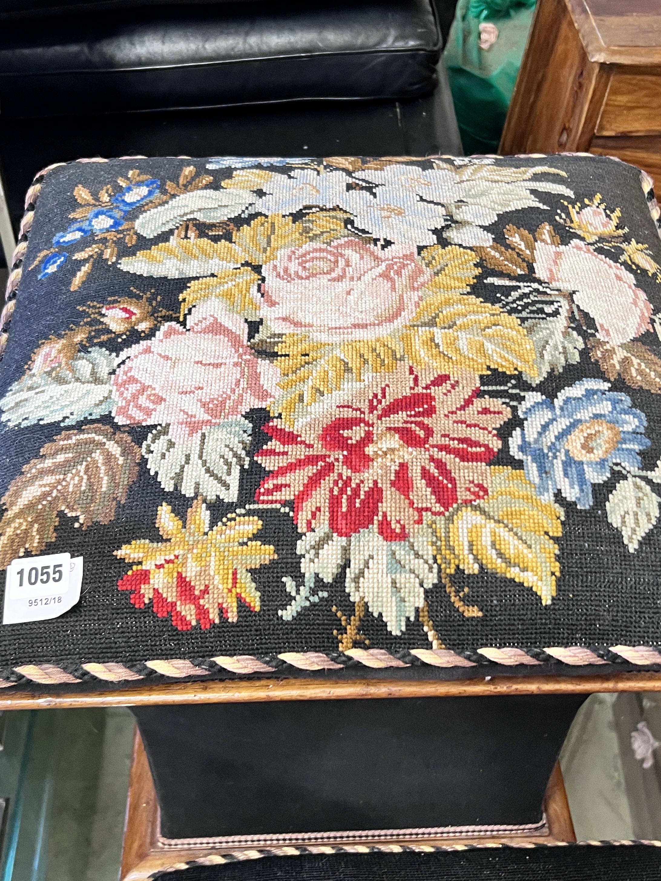 A Victorian ottoman stool with woolwork floral upholstery, width 48cm and a similar footstool, width 48cm